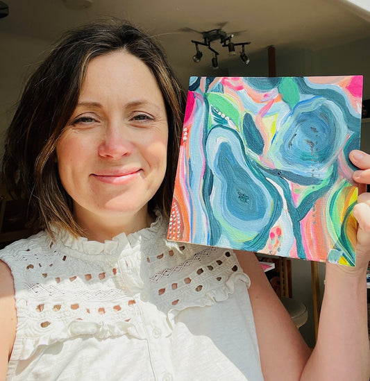 Louise holding a connection abstract painting