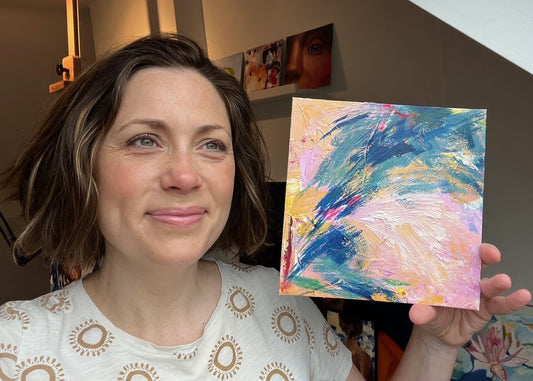 Louise Thompson holding abstract painting