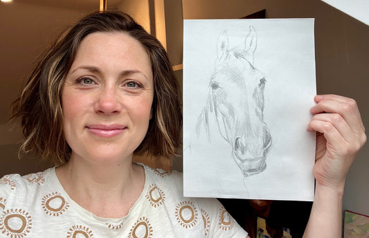 Louise Thompson holding a drawing of a horse