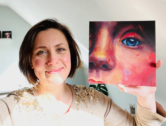Louise holding painting of a face